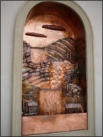 Copper Tuscan wall fountain about 8 feet tall and four feet wide. One of two similar pieces.