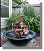 Copper Egret fountain in  townhouse back yard in Baton Rouge