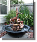 Copper Egret fountain in  townhouse back yard in Baton Rouge