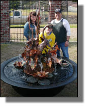 Thibodaux family with their new copper fountain and sugar kettle