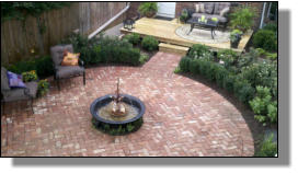 Small kettle and Lance One Iris fountain used as centerpiece of Alexandria, VA backyard renovation on DIY network show